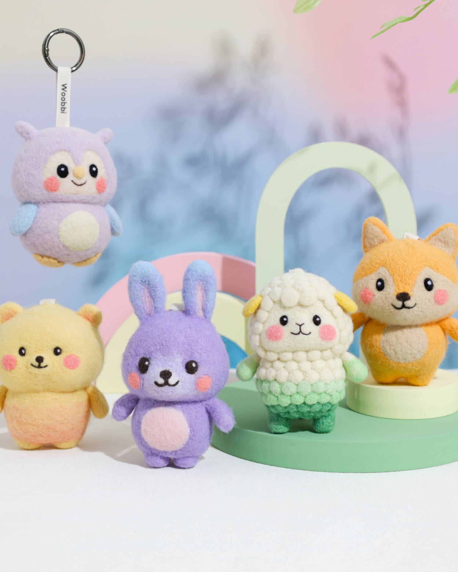 Handcrafted natural wool plush toys from The Originals collection by Woobbi, featuring Bomo the Bear, Filo the Fox, Kiki the Bunny, Luma the Sheep, and Bluebbi the Blueberry, displayed together in soft eco-friendly colors.