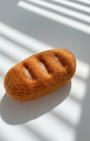 Small handmade baguette wool magnet with soft felted texture and warm tones