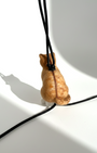 Back view of Merino wool needle-felted cat-shaped pendant on a black lambskin cord against a white background.