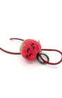 Front view of needle-felted red apple keychain with matching red leather cord, featuring a peaceful sleeping expression and green stem.