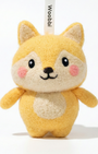 Front view of a handmade Woobbi fox keychain, made from soft yellow and cream wool felt. The fox has pointed ears, rosy pink cheeks, and a happy smiling face with black eyes and nose. It features a white belly patch and is attached to a black metal keyring with a tag labeled 'Woobbi'. The background is plain white.