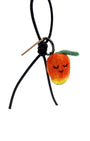 Sustainable needle-felted mango keychain with black leather cord and brown Woobbi brand tag, styled as a tropical bag accessory.