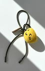 Cute needle-felted lemon smiley face plush charm with olive green cord.