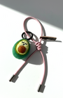 Cute needle-felted avocado accessory with light pink cord and Woobbi brand leather tag.