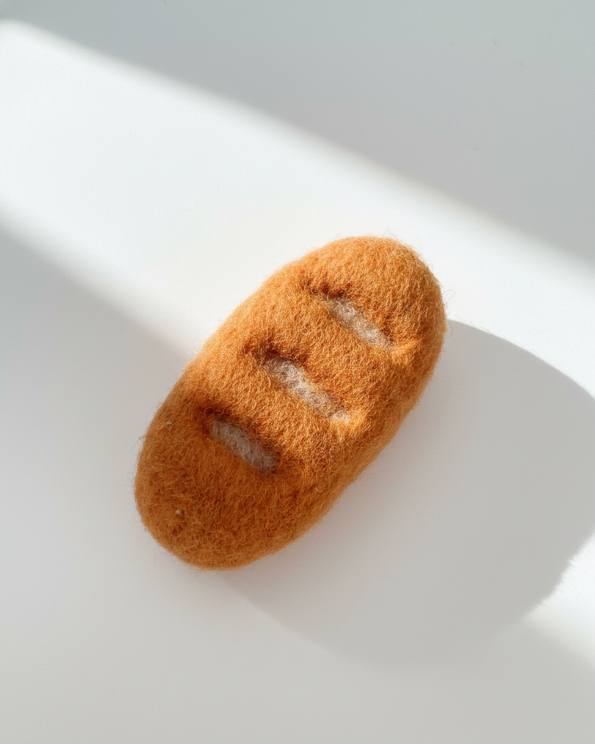 Handcrafted wool baguette magnet inspired by a classic French bread loaf