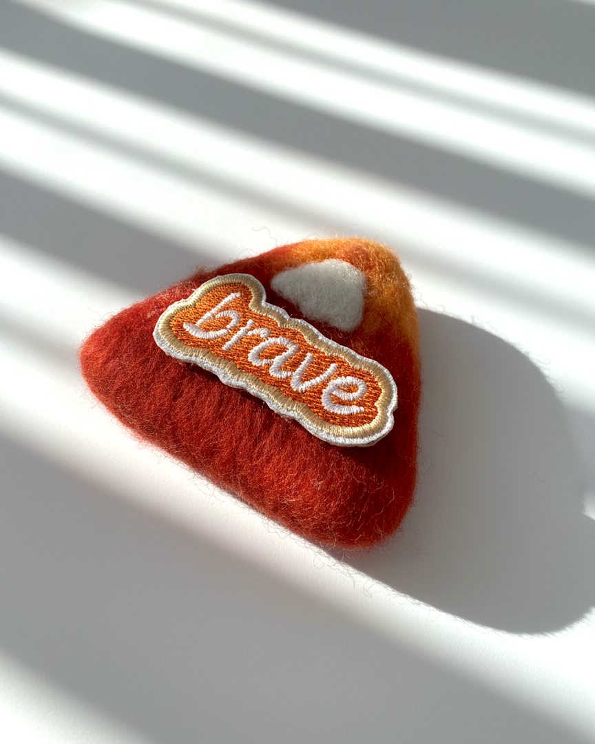 Minimalist rust red wool fridge magnet with Brave patch, handcrafted needle-felted home decor