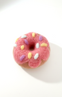 Handmade pink frosted donut wool magnet, needle-felted with colorful sprinkle details