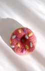 Artisan needle-felted donut magnet made from wool, playful yet minimal design