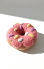 Handcrafted wool donut magnet inspired by a pink frosted donut, minimalist decor