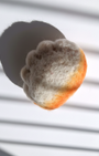 Needle-felted jianjiao dumpling magnet made from natural wool with pleated detail