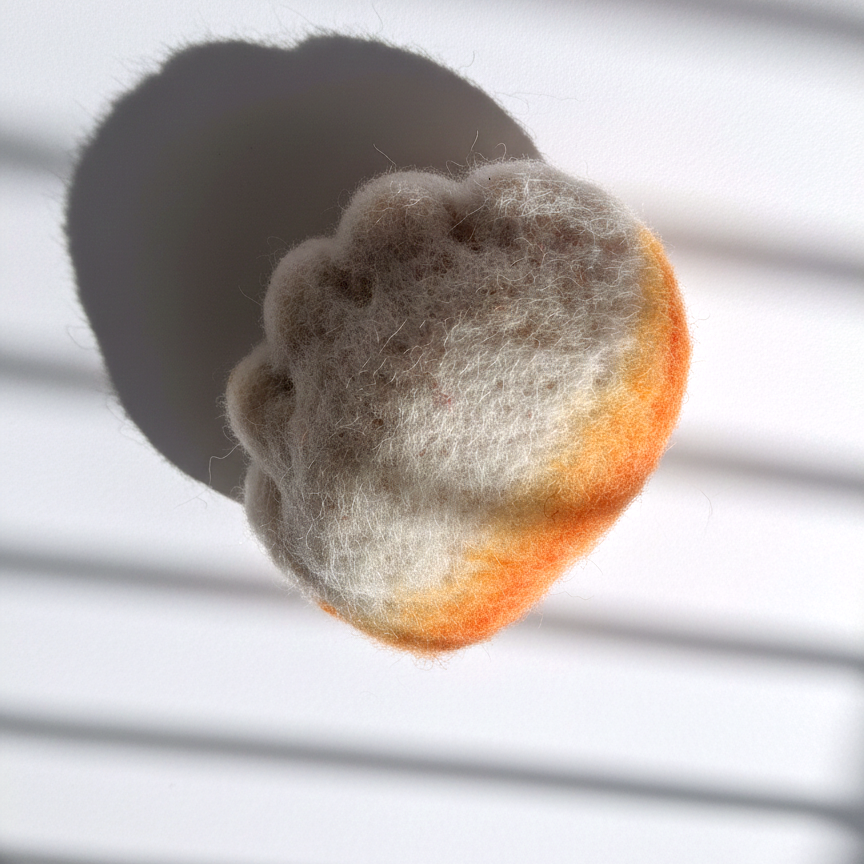 Needle-felted jianjiao dumpling magnet made from natural wool with pleated detail