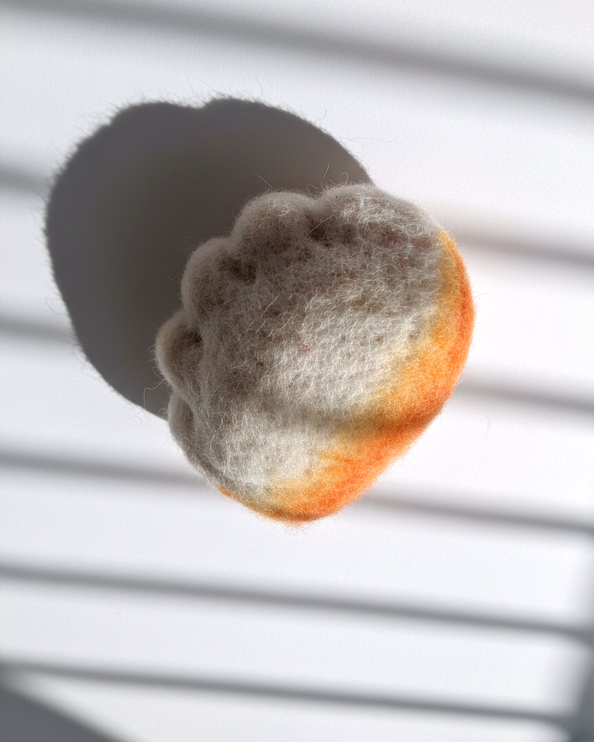 Needle-felted jianjiao dumpling magnet made from natural wool with pleated detail