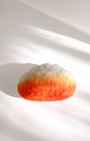 Handcrafted wool fried dumpling magnet with warm golden gradient and rounded form