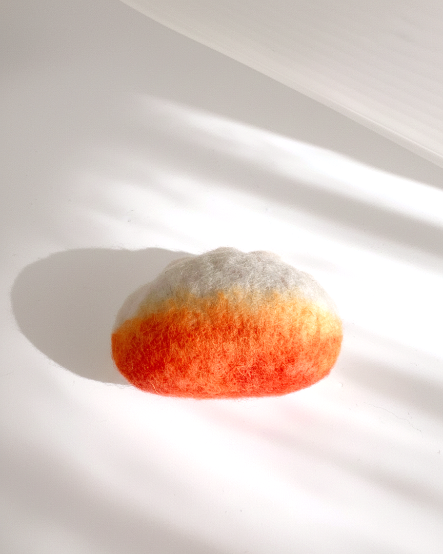 Handcrafted wool fried dumpling magnet with warm golden gradient and rounded form