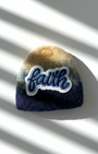 Handmade wool fridge magnet in navy and cream tones with embroidered Faith patch, needle-felted merino woo