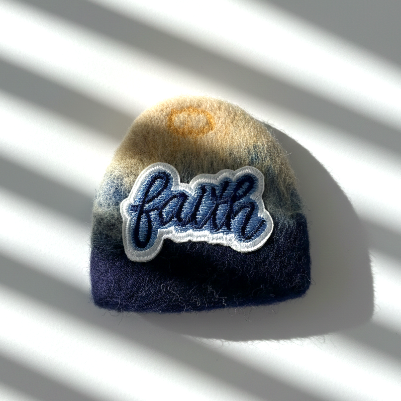 Handmade wool fridge magnet in navy and cream tones with embroidered Faith patch, needle-felted merino woo