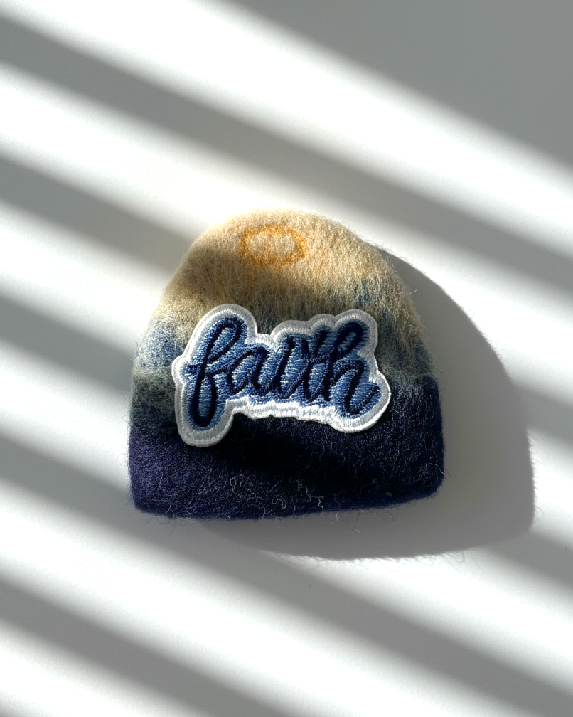 Handmade wool fridge magnet in navy and cream tones with embroidered Faith patch, needle-felted merino woo