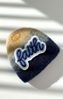 Navy blue needle-felted wool magnet with stitched Faith patch, soft rounded handmade fridge decor