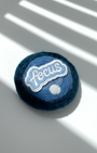 Blue needle-felted wool fridge magnet with stitched Focus patch, round minimalist design made from merino wool
