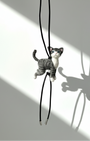 Full view of handmade realistic gray tabby cat wool sculpture charm hanging from black leather strap