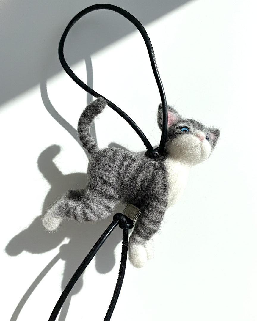 Handmade realistic gray tabby wool cat sculpture charm in standing pose with lifelike expression and raised tail