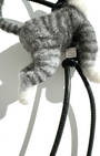 Back view of handmade realistic gray tabby wool cat sculpture charm showing felted fur texture and standing pose