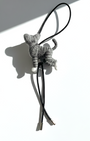 Rear angle of realistic gray tabby wool cat sculpture charm attached to black leather strap