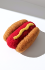 Small handmade wool hot dog magnet with needle-felted bun and sausage detail