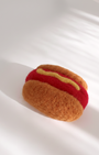 Needle-felted hot dog magnet made from natural wool, minimalist food design