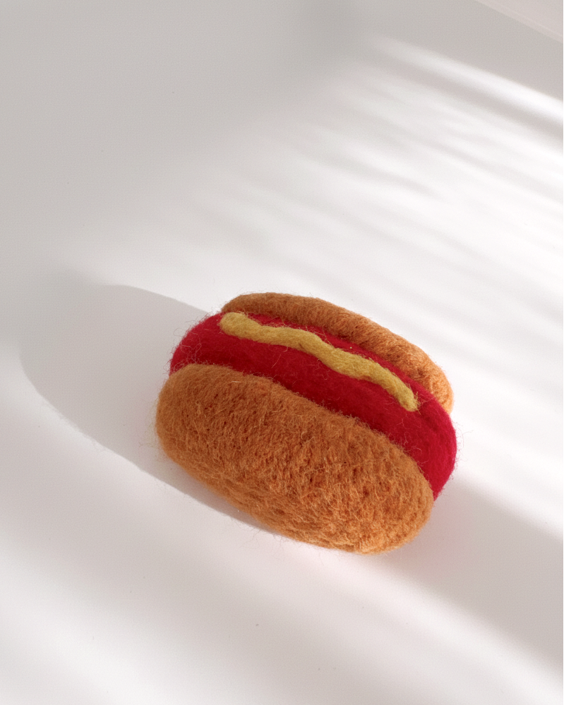 Needle-felted hot dog magnet made from natural wool, minimalist food design