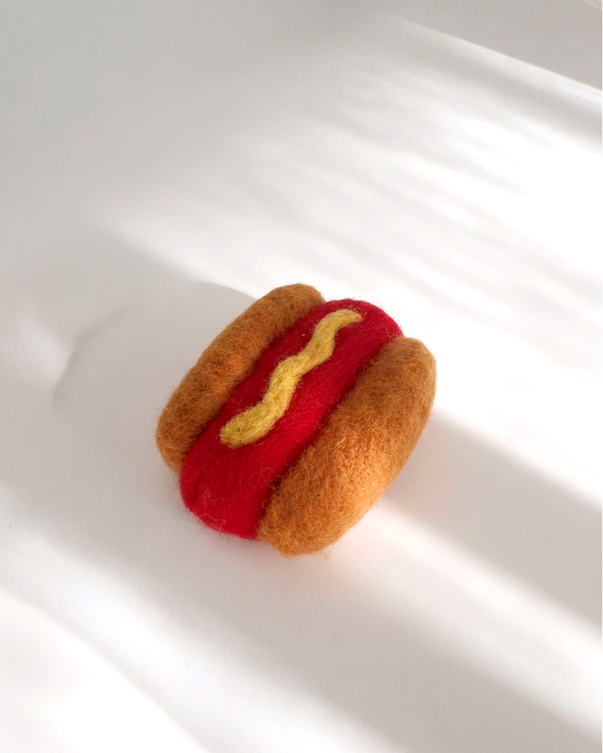 Handmade hot dog wool magnet, needle-felted with soft texture and classic color contrast