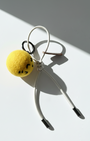 Handmade smiley face lemon felt charm with cream white cord and metal tips.