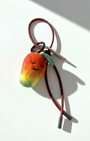 Miniature needle-felted mango keychain with dark red burgundy cord.