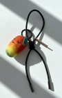 Artisan felted mango accessory with black leather cord and silver hardware
