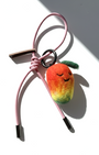 Needle-felted mango bag charm with pink cord and silver aglets.