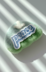 Handcrafted merino wool fridge magnet in green gradient tones featuring Peace embroidery patch