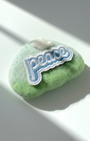 Minimalist green wool fridge magnet with Peace patch and white cloud accent, handmade felt home decor