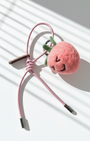 Blush pink wool felt strawberry charm with pink leather loop strap, handmade needle felt fruit accessory photographed in modern studio sunlight