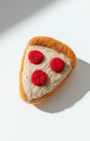 Handmade wool pepperoni pizza slice fridge magnet, needle-felted with soft texture on white background