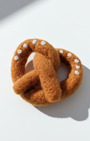 Needle-felted pretzel magnet made from natural wool with classic pretzel shape