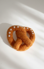 Artisan needle-felted pretzel magnet inspired by a traditional soft pretzel