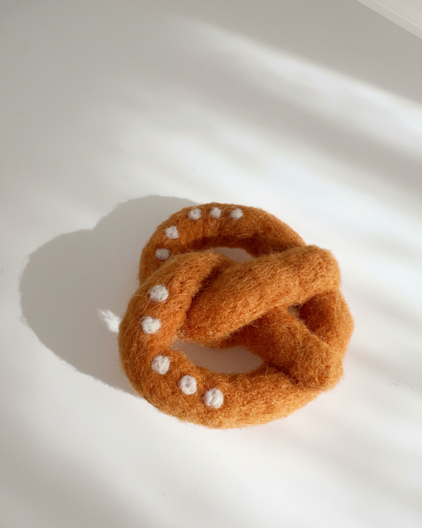Natural wool pretzel magnet handmade with dense needle-felted construction