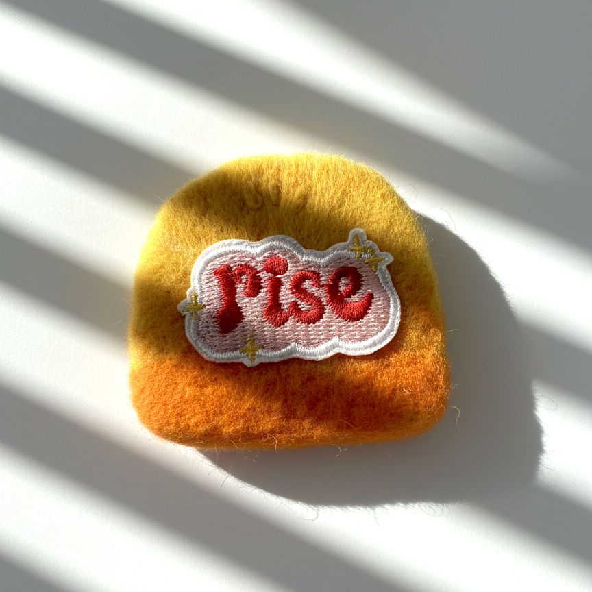 Minimalist yellow wool fridge magnet with Rise patch and star accents, handmade needle-felted home decor
