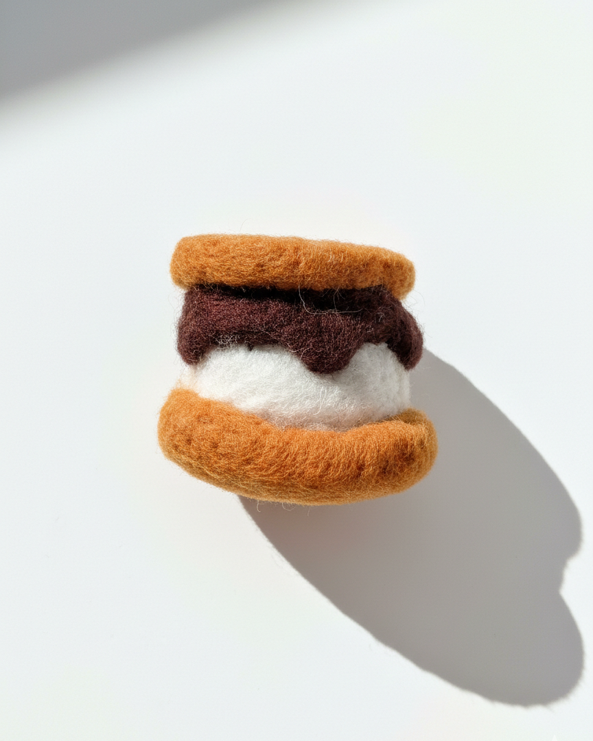 Handcrafted wool s’more magnet with toasted biscuit texture and layered detail