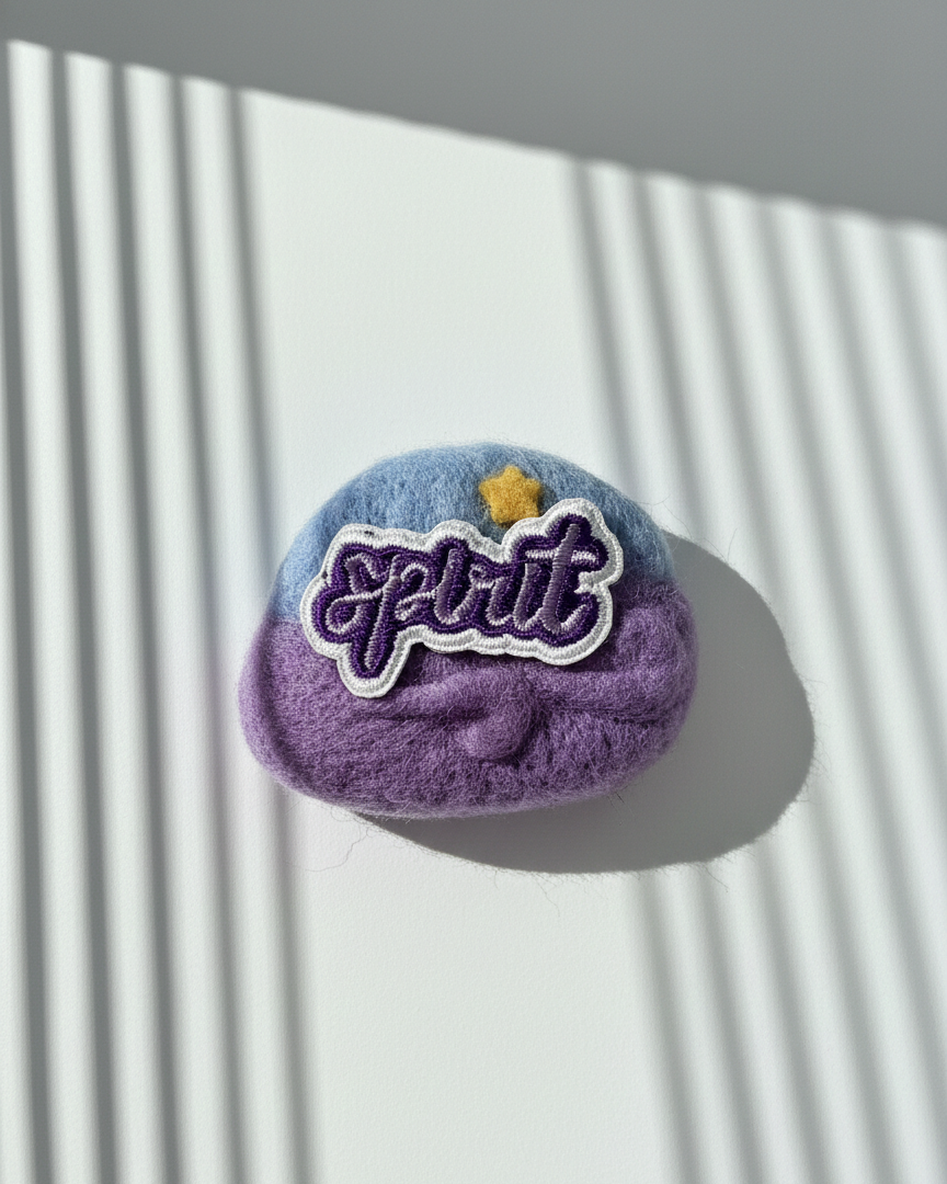 Handmade wool fridge magnet in purple and blue tones with embroidered Spirit patch and star detail, needle-felted merino wool
