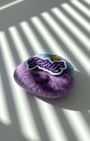 Handmade merino wool fridge magnet with Breathe patch, calming purple felt texture and subtle star accent