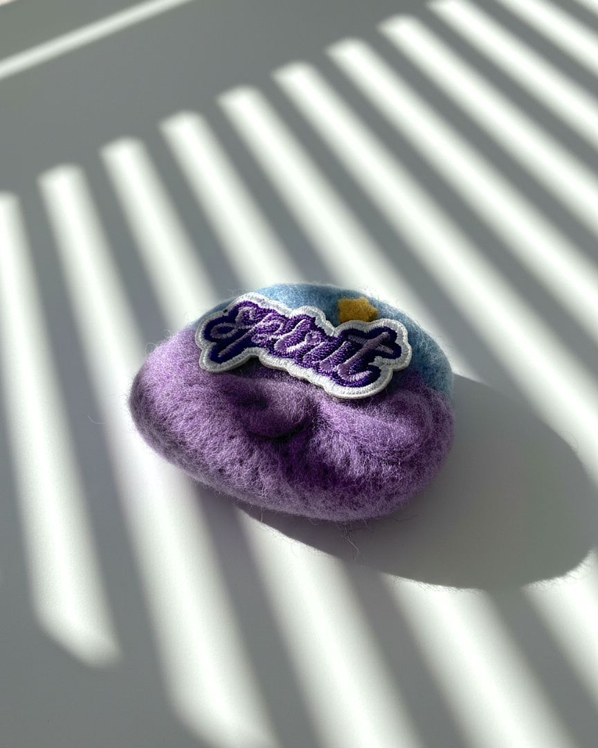 Handmade merino wool fridge magnet with Breathe patch, calming purple felt texture and subtle star accent