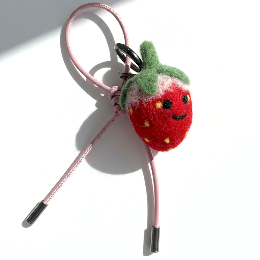Handmade wool felt strawberry keychain with pink leather loop, needle-felted fruit bag charm