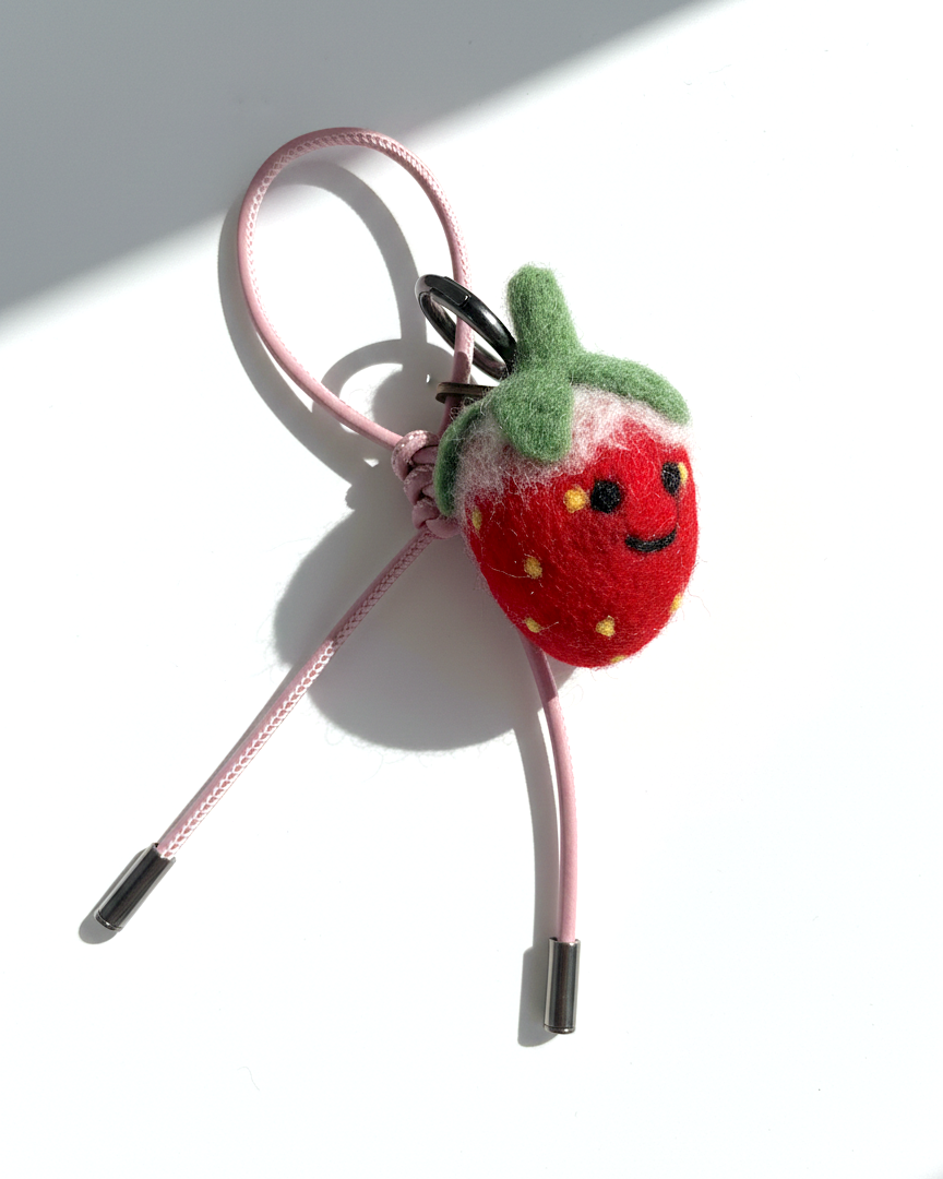 Handmade wool felt strawberry keychain with pink leather loop, needle-felted fruit bag charm