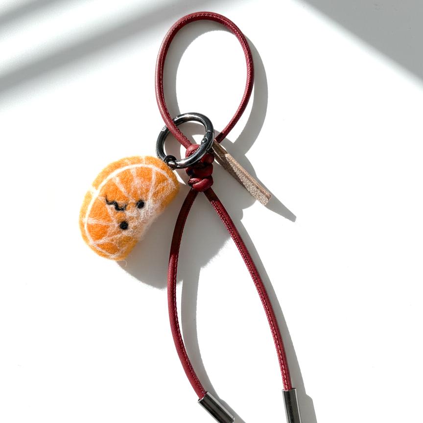 Needle felt orange slice keychain with red leather loop, handmade wool citrus charm